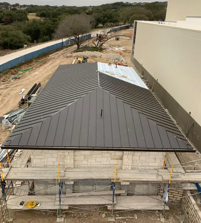 Metal roof new construction with scaffolding in Savoy