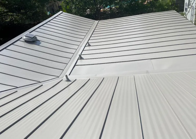 Solar attic fan installed on a metal roof for Roof Ventilation in Savoy